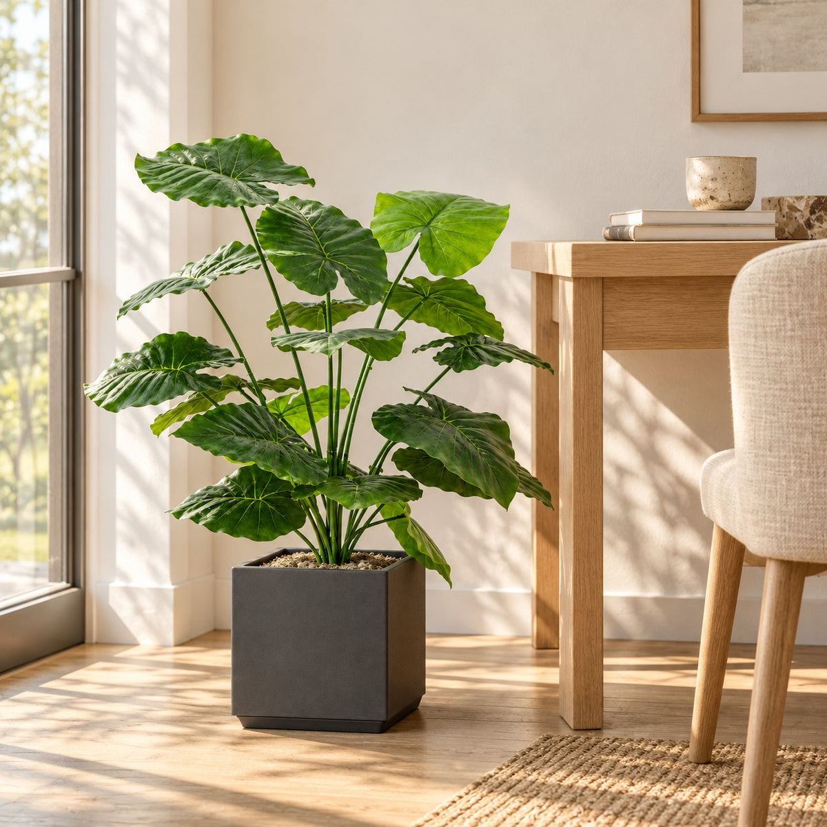 Artificial Alocasia in a grey square planter, styled in a real home