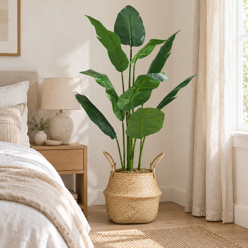 Artificial Bird of Paradise in a seagrass belly basket, styled in a real home